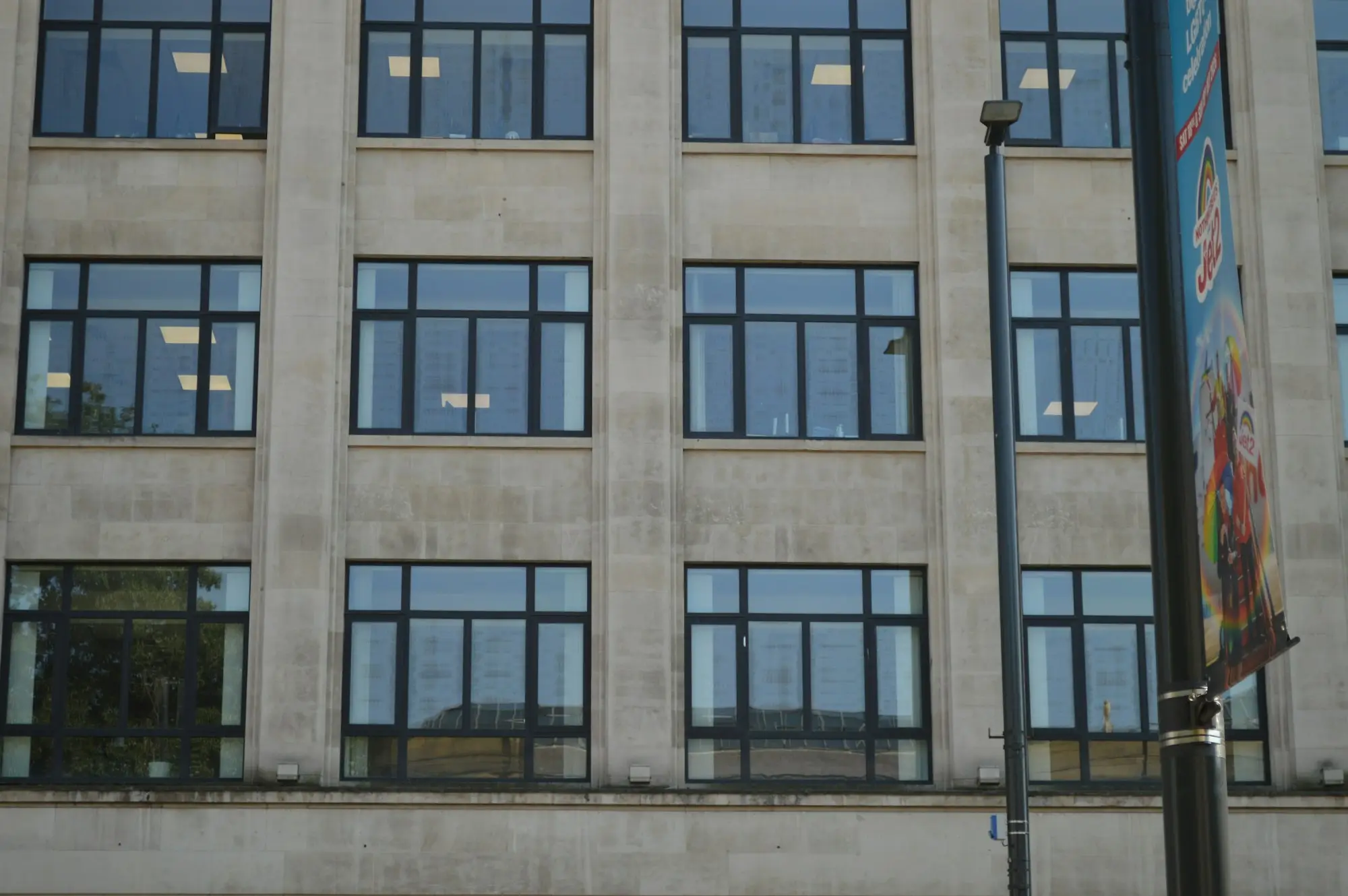 Concrete commercial building facade with rows of windows