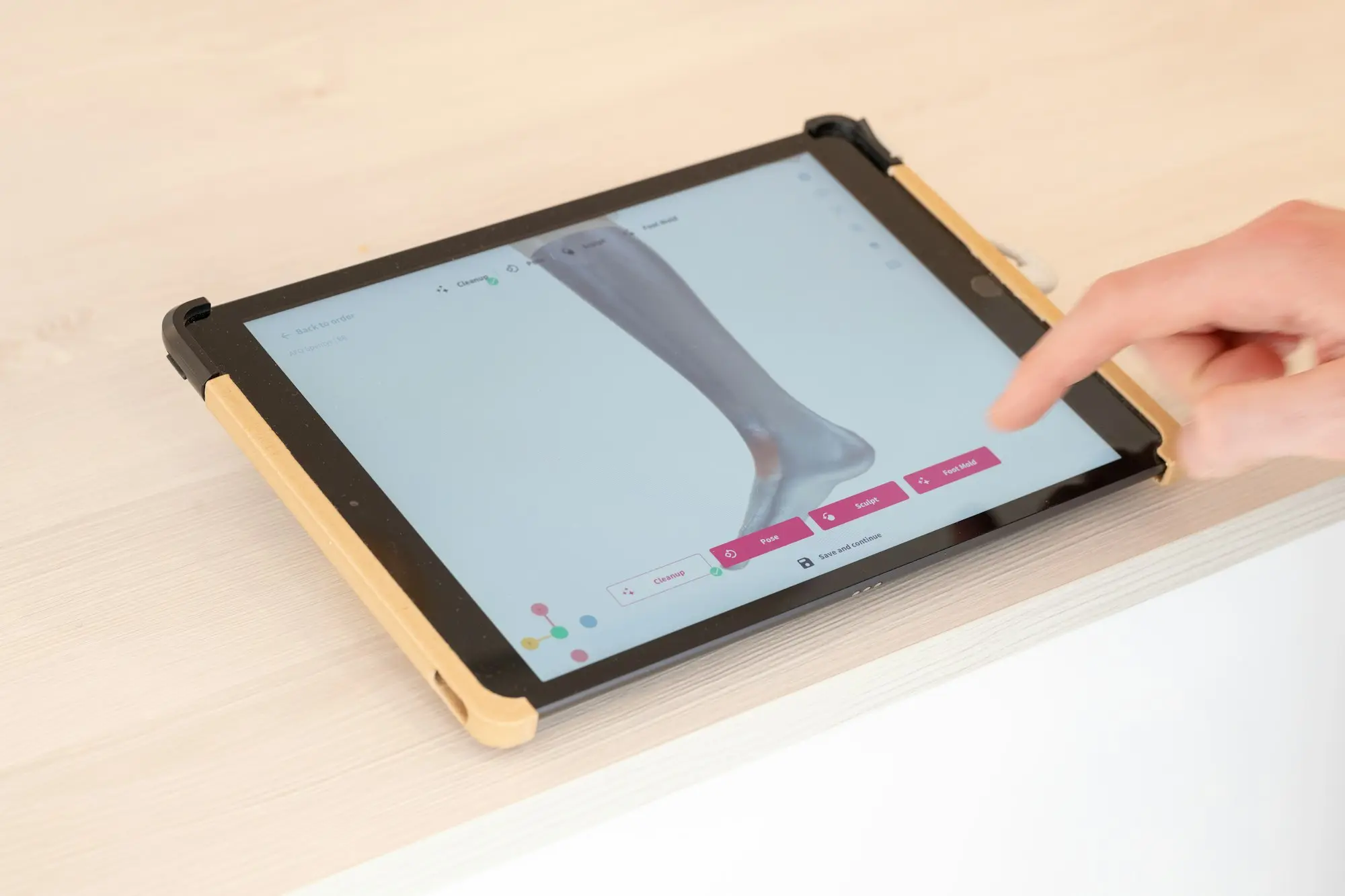 Person pointing at a tablet screen while going through business figures
